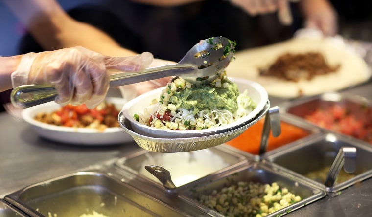 Chipotle restaurant workers preparing orders.