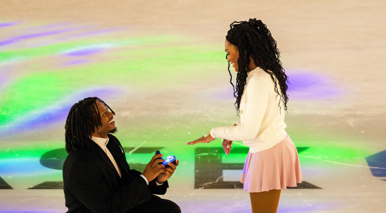 Douglas Brown proposing to Ivana Hughes in the middle of the Rockefeller Center after renting the rink out.