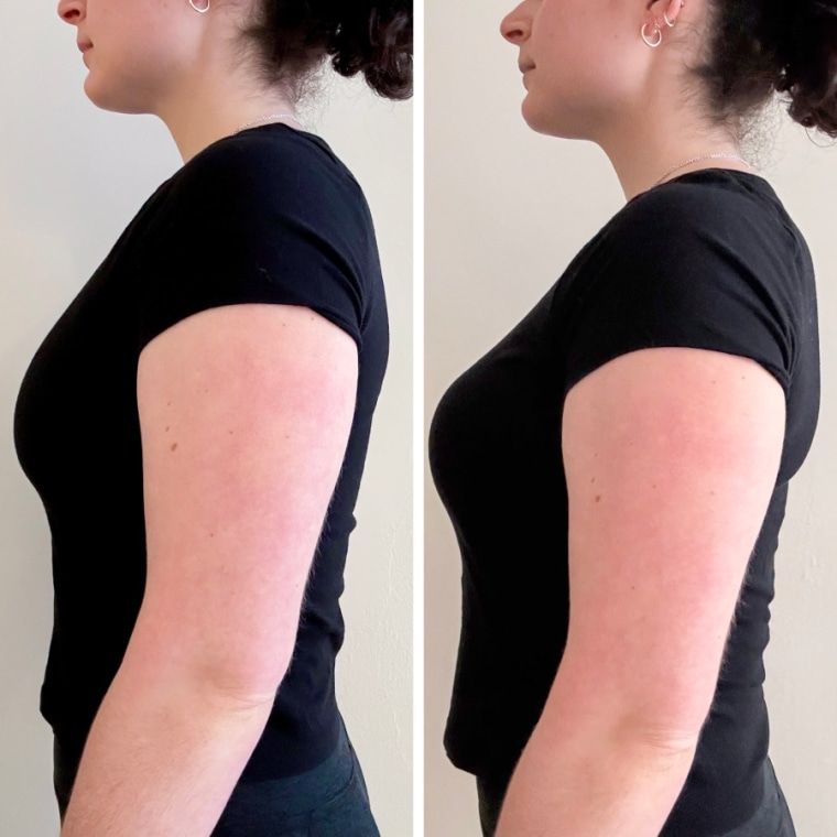 Woman wearing a black Forme Power Bra and standing in front of a white wall.