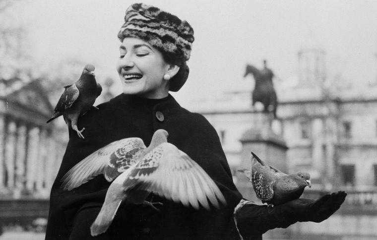 Opera Soprano Maria Callas holds and feeds pigeons in Trafalgar Square, in London, Feb. 4, 1957. 