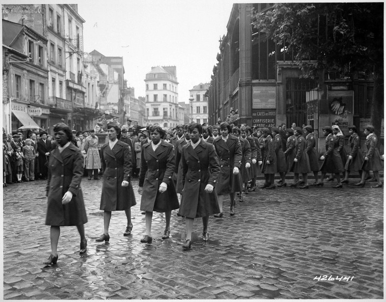 Members of the 6888th Central Postal Directory Battalion take part in a parade ceremony in honor of Joan d'Arc at the marketplace where she was burned at the stake in 1945.