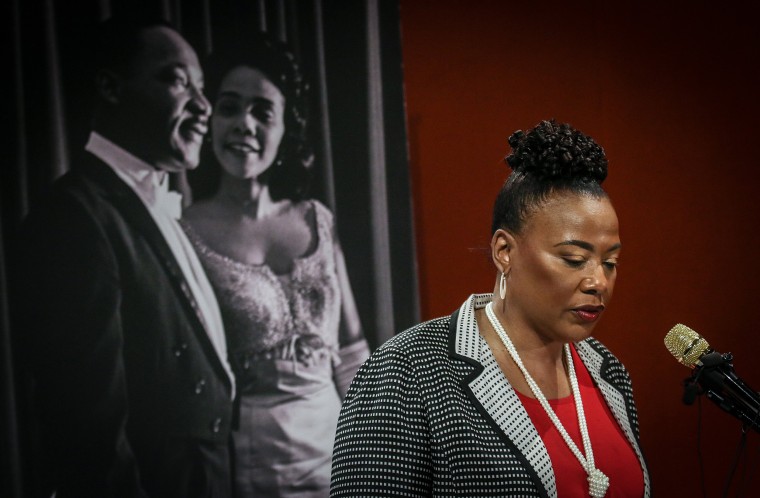 Bernice King speaks in front of an image of Martin Luther King and Coretta Scott King on the wall behind her