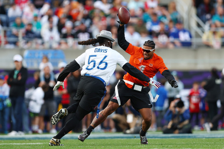 Ja’Marr Chase #1 of the Cincinnati Bengals and AFC tries to avoid having his flag pulled by Demario Davis #56 of the New Orleans Saints and NFC.