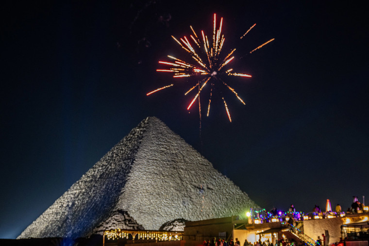 Fireworks explode above the Great Pyramids in Cairo on December 31, 2024.