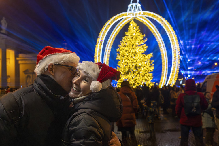 A couple kisses as they celebrate New Year on Cathedral Square in Vilnius, Lithuania.