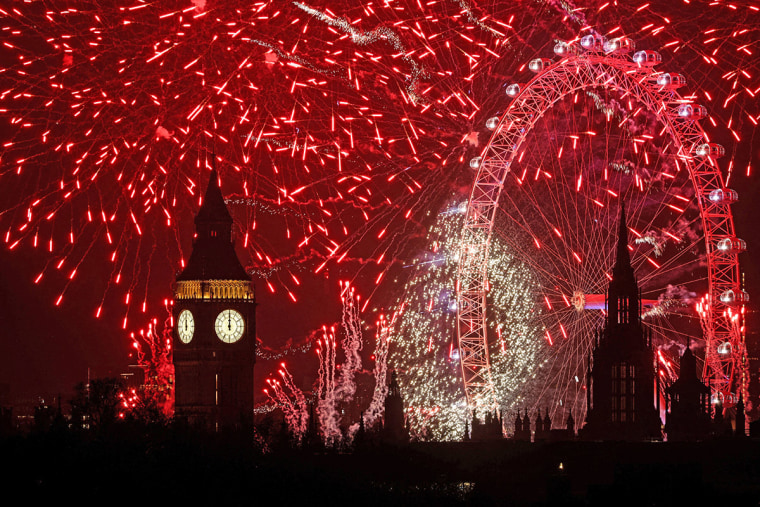 Fireworks explode in the sky around the London Eye and The Elizabeth Tower, which houses the bell known as "Big Ben," in London, at midnight on January 1, 2025. 