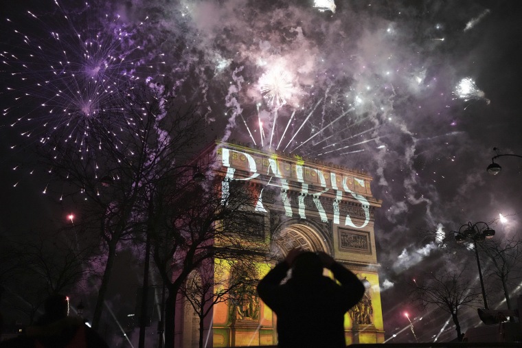 A light show is projected on the Arc de Triomphe in Paris.