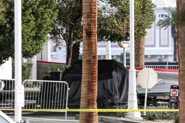 Firefighters work at the Tesla Cybertruck which burned at the entrance of Trump Tower in Las Vegas