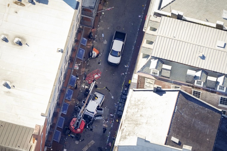 Investigators work the scene after a person drove a vehicle into a crowd 