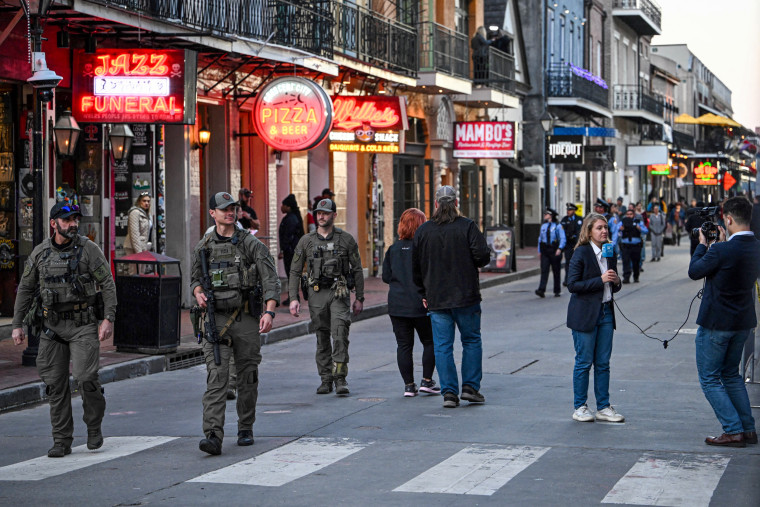 Police walking down Bourbon Street.