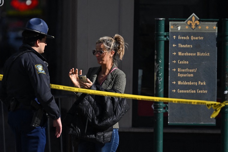 A woman speaks with a police officer near a blocked off street in the French Quarter on Jan. 2, 2025 in New Orleans.