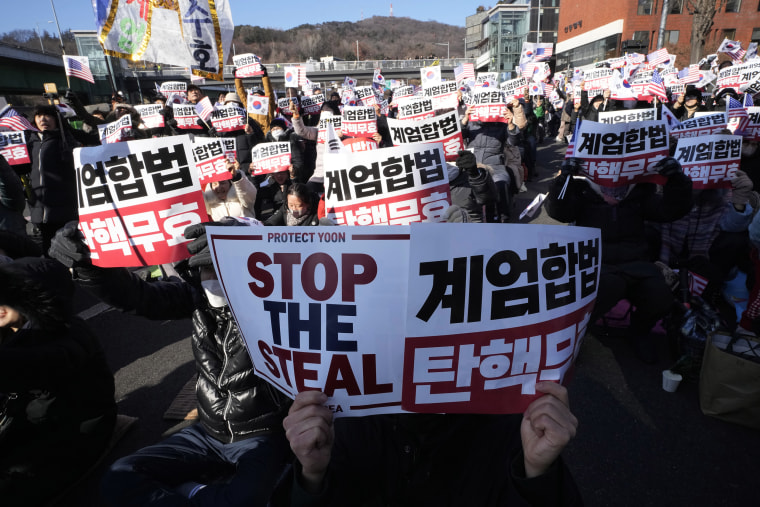 The signs read, "Oppose impeachment." 