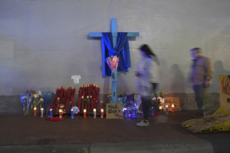 People walk past a memorial at Bourbon and Canal Street in the French Quarter, Thursday, Jan. 2, 2025 in New Orleans. 