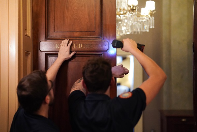 Workers for the Architect of the Capitol place Sen. John Thune’s nameplate on the Republican Leader’s suite in the U.S. Capitol, replacing McConnell’s name, which has been there for the last 18 years.