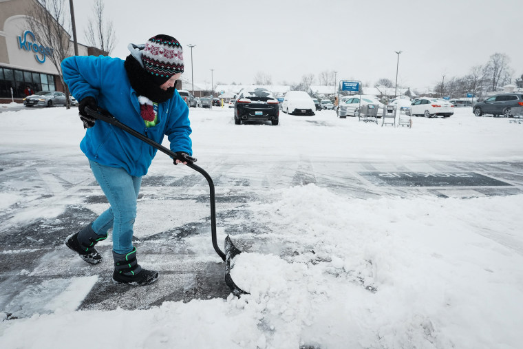 SyndicationStore clerk Brandy Sabie shovels the parking lot at the Kroger: The Courier-Journal