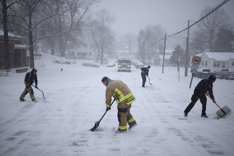 Firefighters shovel snow in Kentucky.