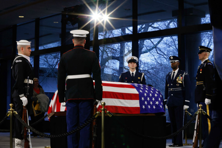 The Honor Guard surrounds former President Jimmy Carter's flag-draped casket as he lies in repose at the Jimmy Carter Presidential Library and Museum on Jan. 6, 2025 in Atlanta.