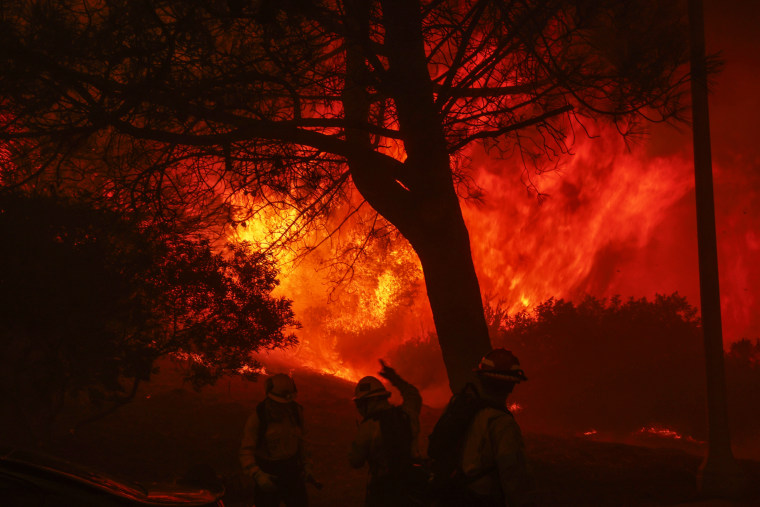  A brush fire burns near homes in Pacific Palisades