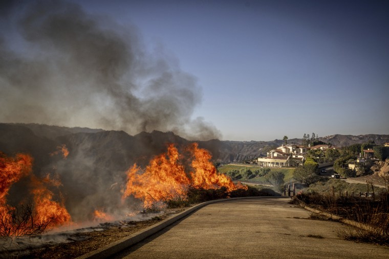  A brush fire burns near homes in Pacific Palisades