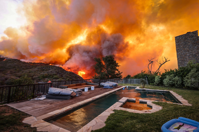  A brush fire burns near homes in Pacific Palisades