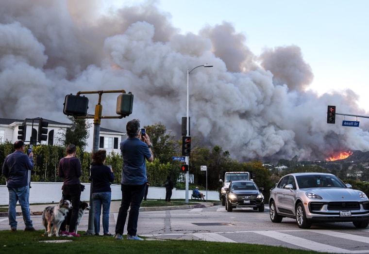  A brush fire burns near homes in Pacific Palisades