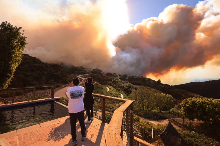  A brush fire burns near homes in Pacific Palisades