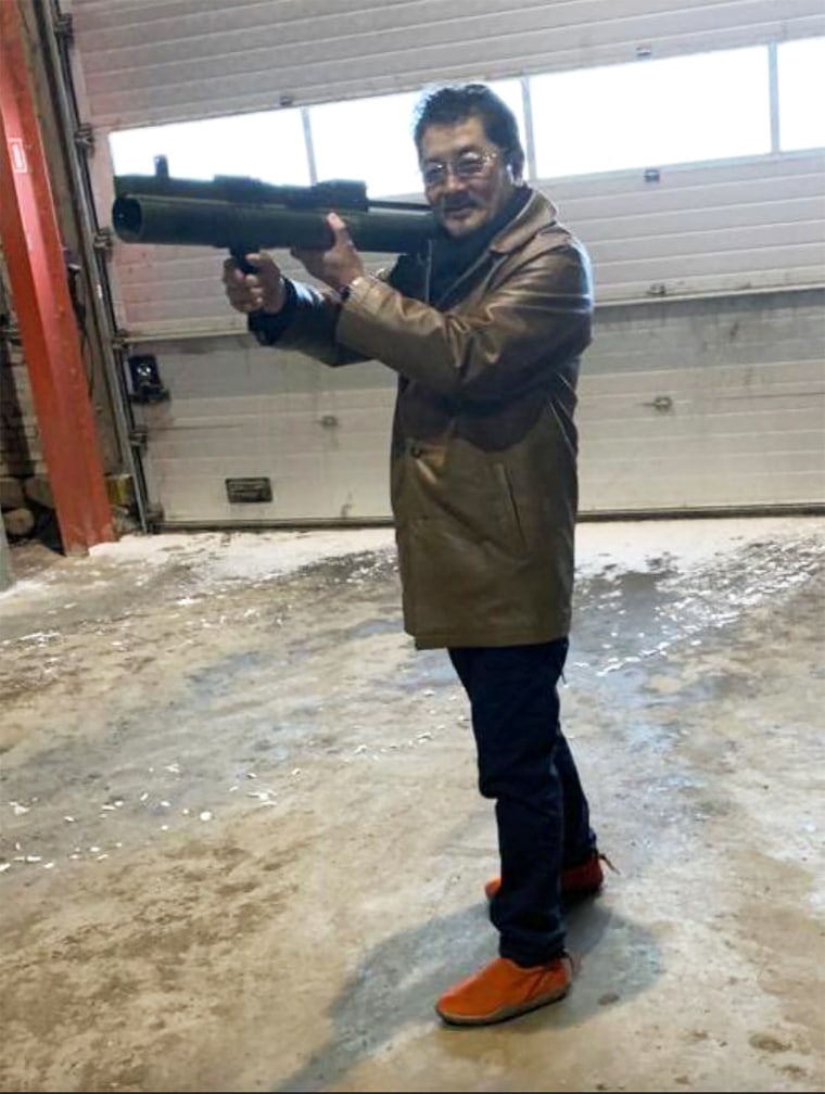 Takeshi Ebisawa poses with a rocket launcher during a meeting with an informant at a warehouse in Copenhagen crime syndicate 