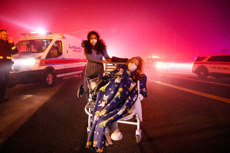 A ferocious wildfire in a Los Angeles suburb devoured buildings and sparked panicked evacuations January 7, as hurricane-force winds tore through the region.