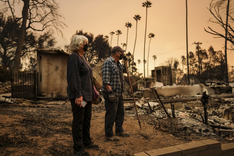 Paul Perri and Michelle Miner search through their daughter's fire-ravaged property