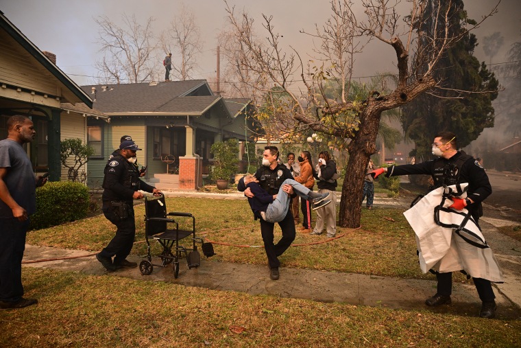 Rampaging wildfires around Los Angeles have killed at least two people, officials said January 8 as terrifying blazes leveled whole streets, torching cars and houses in minutes.