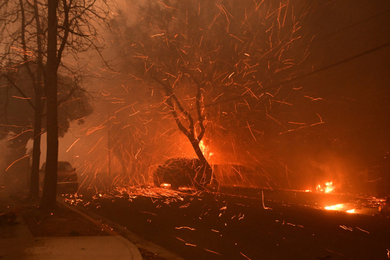 Embers from the Eaton Fire fly down a residential street in Altadena, Calif., on Jan. 8, 2025. 