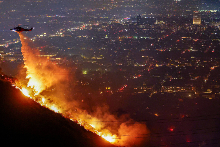 A firefighting helicopter drops water.