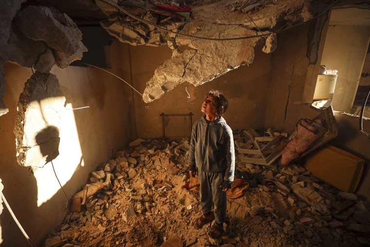 A Palestinian girl looks at the rubble of a building destroyed in an Israeli strike in Deir el-Balah, Gaza, on Jan. 9, 2025.