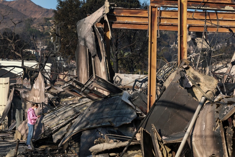 A congregant looks through the remains of Community United Methodist Church.