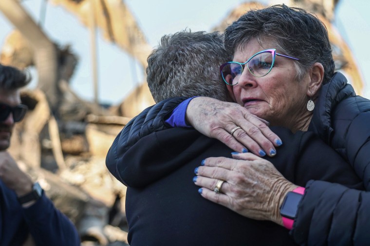 A supporter hugs Rev. John Shaver.