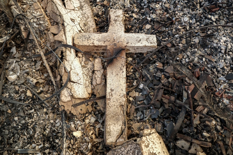 A cross rests in the remains of Community United Methodist Church.