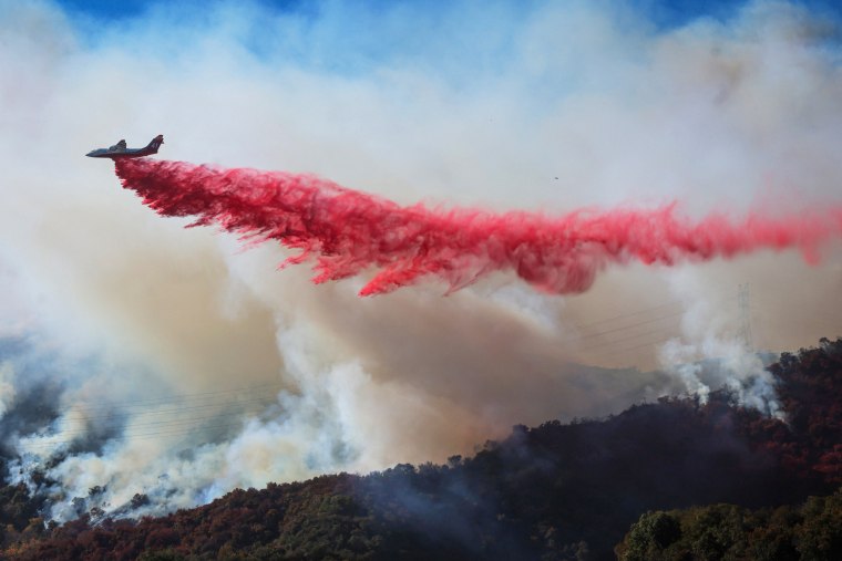 Retardant is dropped as the Palisades Fire grows.