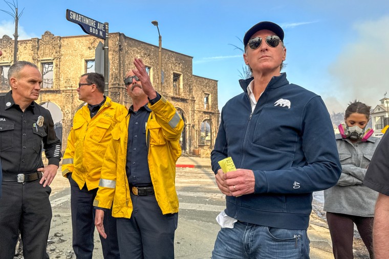 Gavin Newsom, right, surveys damage in Pacific Palisades