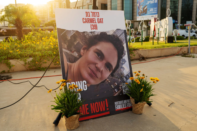 A poster with the photo of Israeli hostage, Carmel Gat, held