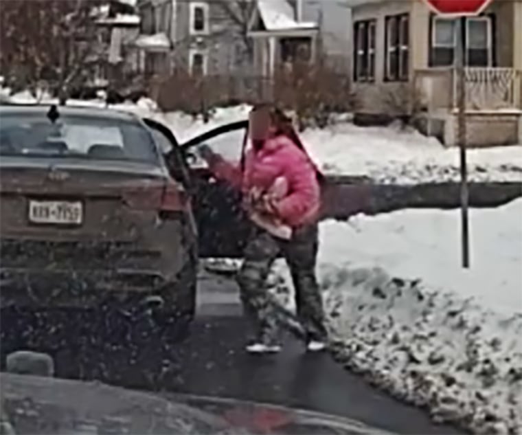 A still from a patrol vehicle’s  dashcam shows a female suspect fleeing from a stolen car. Suspect's face obscured by sheriff's office.