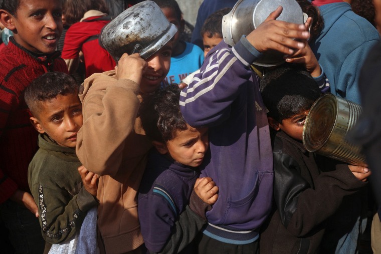 Palestinian children gather to receive food aid in Deir al-Balah, Gaza, on Jan. 16, 2025.