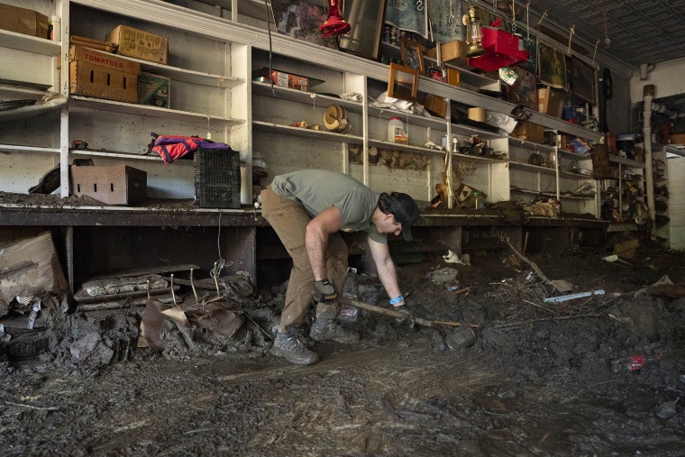 Volunteers shovel debris and mud out of the Whitson Furniture and General Store in Green Mountain, North Carolina, October 6, 2024, in the aftermath of Hurricane Helene. Whitson Furniture and General Store is a 64 year old small family business.