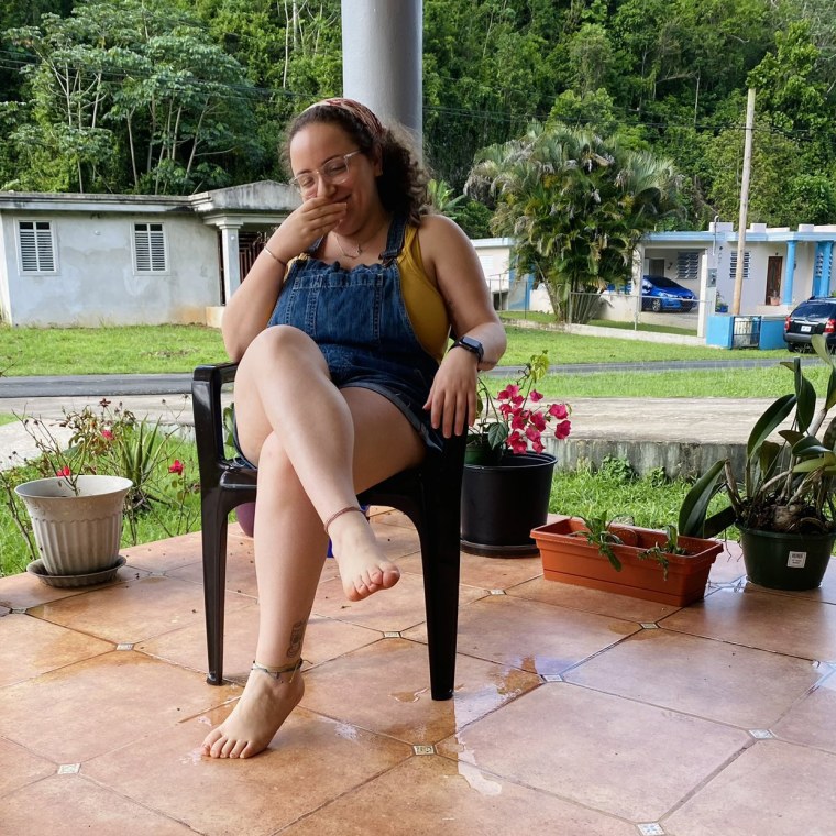 Dinatalia Farina sitting on her grandmother's porch in the town of Florida, in Puerto Rico.