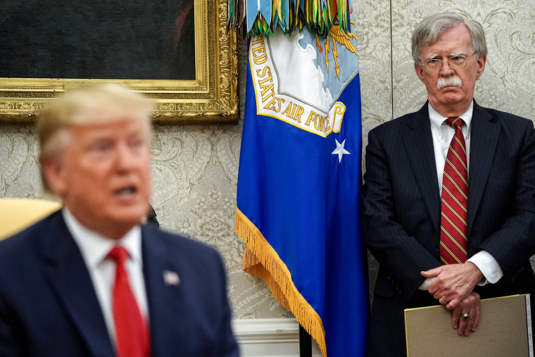 John Bolton listens to Donald Trump.