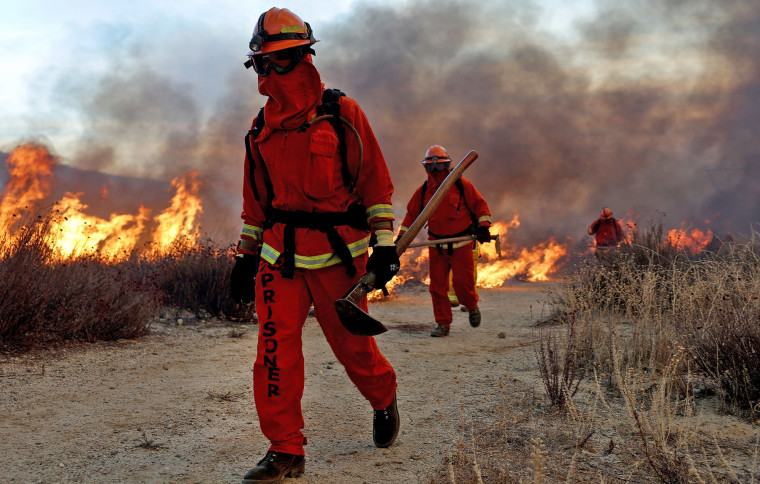 Inmate firefighters work as the Hughes Fire burns north of Los Angeles 