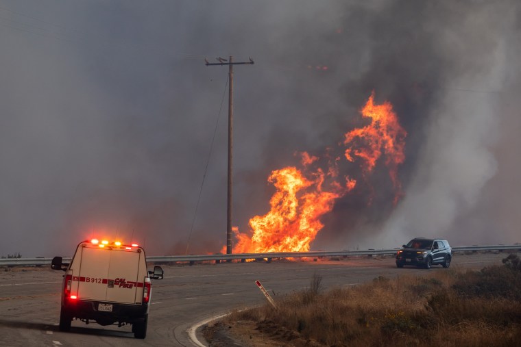 Flames from the Hughes Fires approach Lake Hughes Road in Castaic, Calif., on Jan. 22, 2025. 