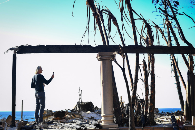 Sebastian Harrison surveys the charred ruins of his home in Malibu, Calif., on Jan. 21, 2025.