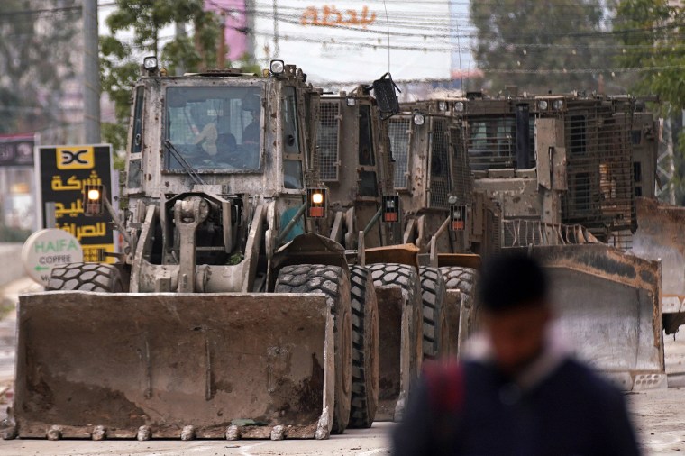 A Palestinian official reported shooting and explosions in the flashpoint West Bank town of Jenin on January 22, as Israeli forces pressed a raid that the military described as a "counterterrorism" operation.