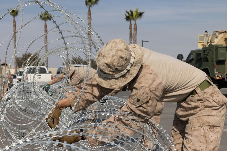 People set up barbed wire