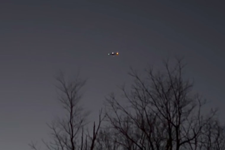 A possible drone flies over trees in Clinton Township, N.J. 